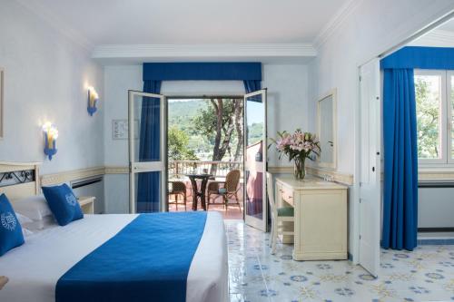 a hotel room with a bed and a balcony at Hotel Hermitage in Portoferraio