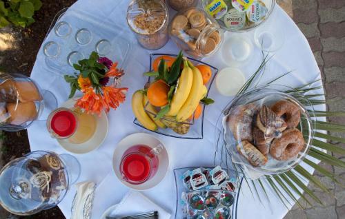 a white table with plates of food on it at Amaka in Custonaci