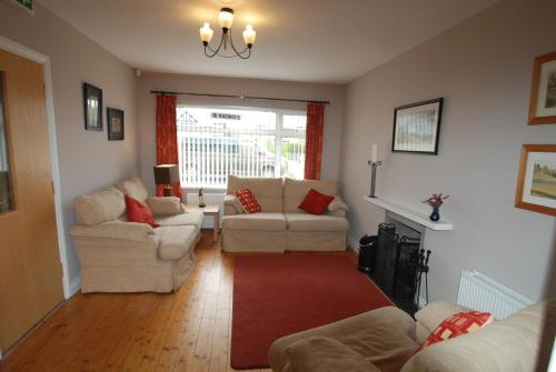 a living room filled with furniture and a window at Aaranmore Lodge Guest House in Portrush