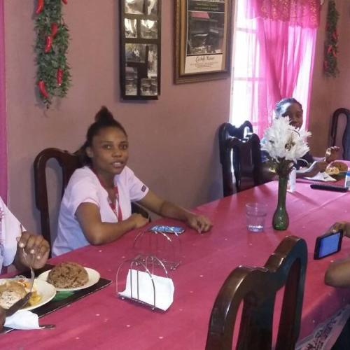 a young girl sitting at a pink table at La Belle Maison Milot in Samson