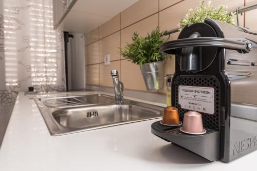 a mixer on a kitchen counter next to a sink at Apartments Donat in Zadar