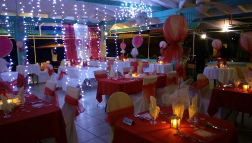 a room with tables and chairs with lights and balloons at Timothy Beach Resort in Frigate Bay