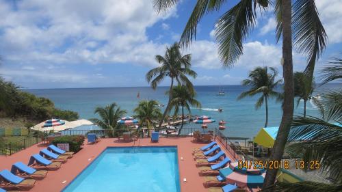 a view of a pool and the ocean from a resort at Timothy Beach Resort in Frigate Bay