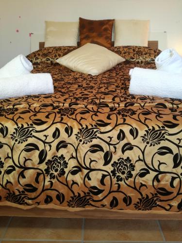 a large bed with a black and brown blanket at Casa VeroSol in Castelsardo