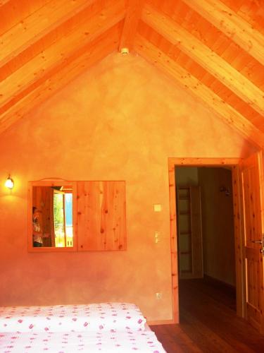 a bedroom with a white bed and a mirror at Appartments Helvetia in Villabassa