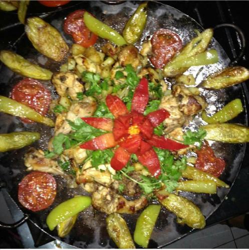 a plate of food with peppers and other vegetables at Hotel Bulaq in Turist