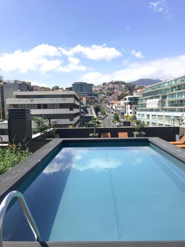 a large swimming pool on top of a building at Parkside Marina Vista - by LovelyStay in Funchal