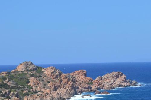 a view of the ocean with rocks in the foreground at Sardegna Isola Rossa La Terrazza panoramiccissimo Cod iun S 8250 in Trinità dʼAgultu