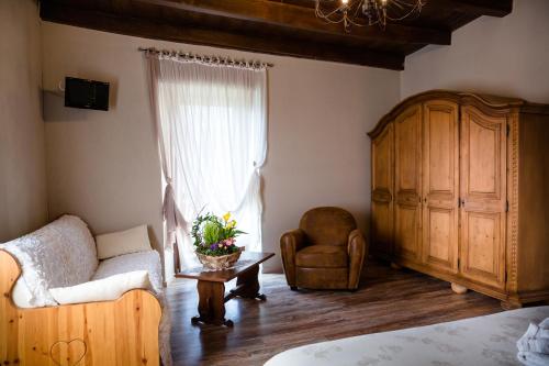 a living room with a couch and a chair at Ca' Baetti l'Antica Corte in Roncola