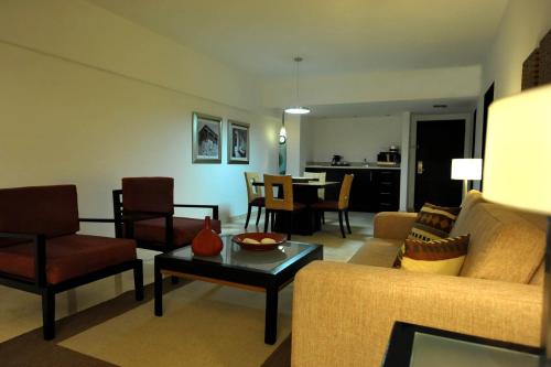a living room with a couch and chairs and a table at Radisson Hotel Santo Domingo in Santo Domingo