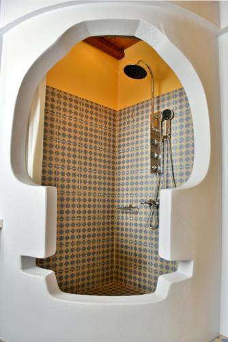 a bathroom with a shower with a wall at Manolia in Hydra