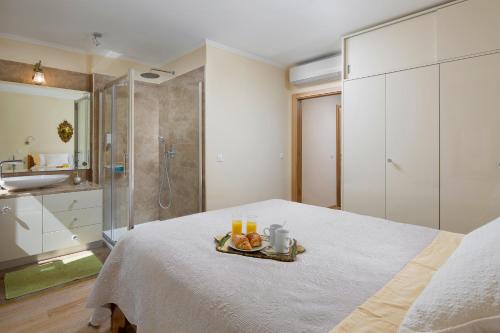 a bedroom with a bed with a tray of fruit on it at Valdibora Sea View Residence in Rovinj