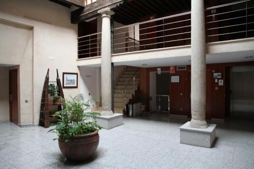 a building with a staircase and a potted plant at Hotel Santa Isabel in Toledo