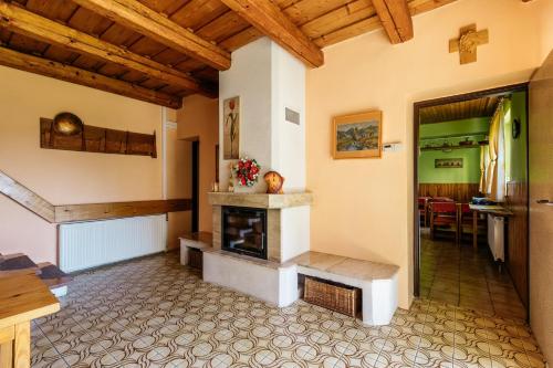 a living room with a fireplace and a table at Homestay Gustav Halas in Terchová
