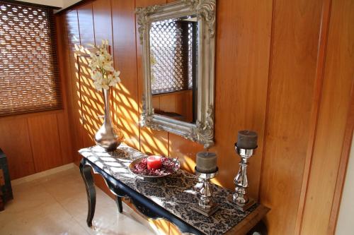 a table with a mirror and a bowl of fruit on it at Hotel Santa Isabel in Toledo