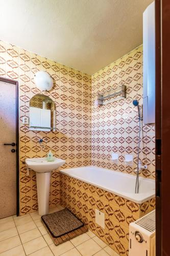 a bathroom with a tub and a sink at Homestay Gustav Halas in Terchová
