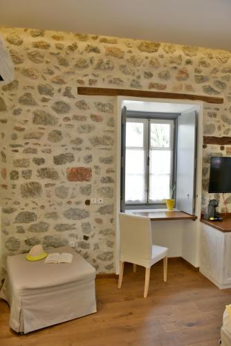 a room with a desk and a window and a chair at Manolia in Hydra