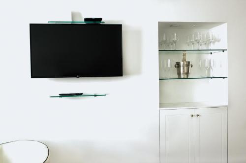 a living room with a tv on a white wall at Old Square Studio Apartment in Split