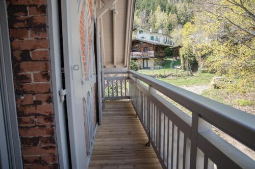 a balcony with a view of a house at Appart'Hotel Aiguille Verte & Spa in Chamonix-Mont-Blanc