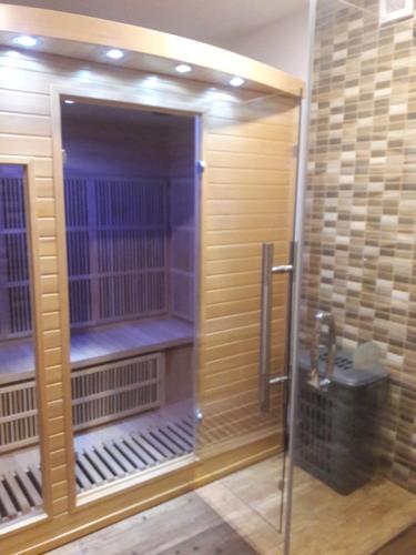 a shower in a bathroom with wooden walls at Penzion Iris Krkonoše in Horní Maršov