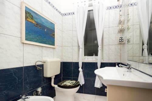 a bathroom with a toilet and a sink at Apartment Leo in Split