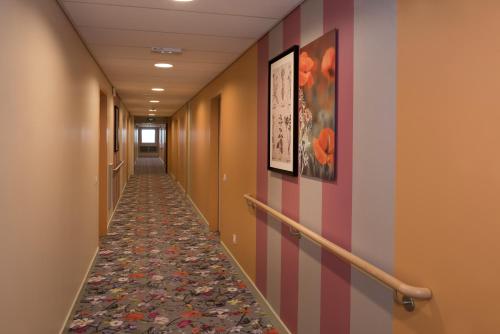 a hallway in a hospital with a tile floor at Domitys Rosa Gallica in Angers