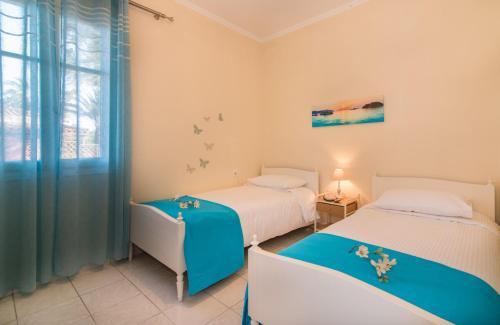 a bedroom with two beds and a window at Olive Tree Apartment in Lagópodhon