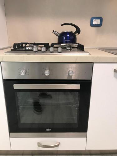 a stove with a tea pot sitting on top of it at Lacisivm Lake View in Lazise