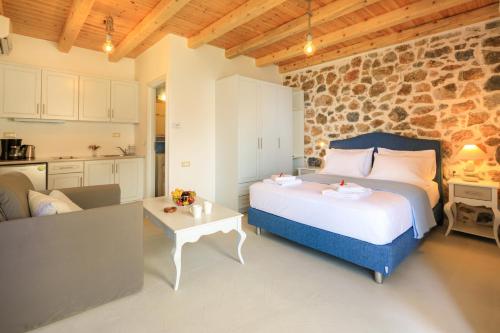 a bedroom with a bed and a kitchen in a room at Molos Apartments in Loutro