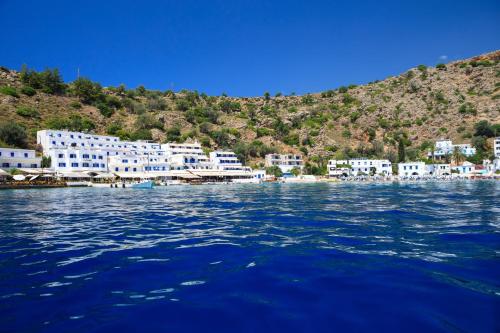 a view of a body of water with buildings at Molos Apartments in Loutro