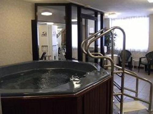 a bath tub with a faucet in a room at Fireside Inn & Suites Portland in Portland