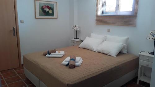 two dolls laying on a bed in a bedroom at Casa Di Mare in Methoni