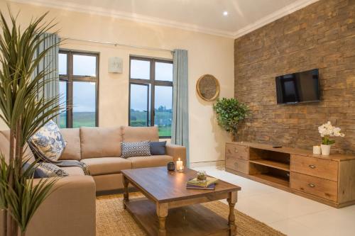 a living room with a couch and a table at The Living Collective - The Gates in Hilton