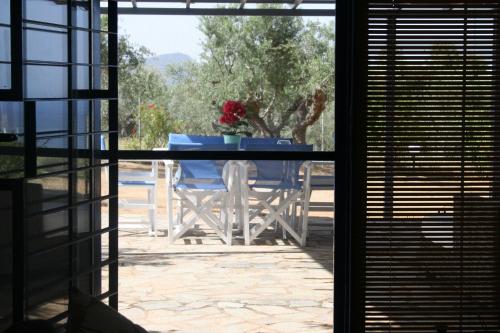 a table with a vase of flowers sitting on a patio at Casa Di Mare in Methoni