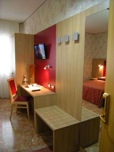 a hotel room with a desk and a bed at Hotel San Carlo in Mestre