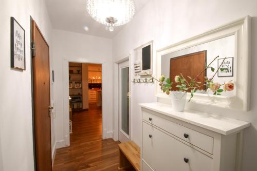 a kitchen with a counter with a vase of flowers on it at City Centre Apartment 1 in Shkodër