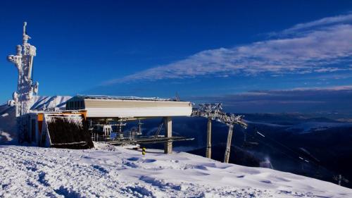 a ski lift on top of a snow covered mountain at Apartment Dony in Donovaly