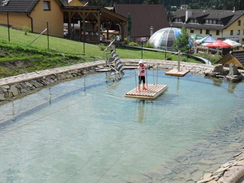 a person standing on a raft in the water at Apartment Dony in Donovaly