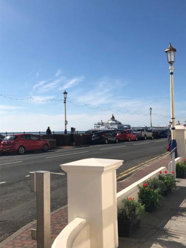 a white bench on the side of a road at Eastbourne Riviera Hotel in Eastbourne