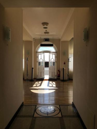 an empty hallway with a door in a building at Eastbourne Riviera Hotel in Eastbourne