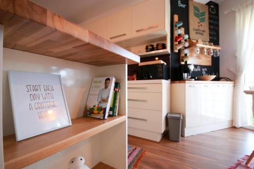 a kitchen with white cabinets and a counter top at City Centre Apartment 1 in Shkodër
