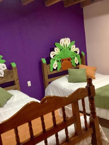 a childs bedroom with two beds with a monster on the wall at Hotel Hacienda Encantada in Real de Catorce