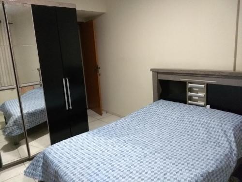 - une chambre avec un lit, une commode et un miroir dans l'établissement Apartamento Guarapari, WI-FI, Vista do Mar, Praia do Morro,100 metros do Mar, à Guarapari