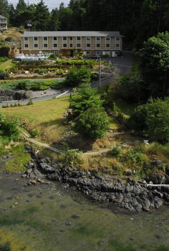 a building on a hill next to a river at High Point Resort in Quathiaski Cove