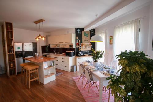 a kitchen and dining room with a table and chairs at City Centre Apartment 1 in Shkodër