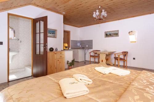 a bedroom with a large bed and a bathroom at Pension Danninger in Piešťany