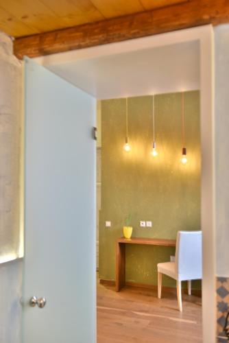 a dining room with a table and a chair at Manolia in Hydra
