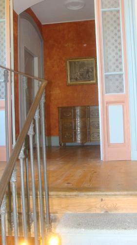 a room with a staircase and a wooden wall at Château des Grèzes in Agnat