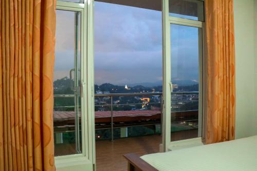 an open window with a view of a city at Mount Palace in Kandy