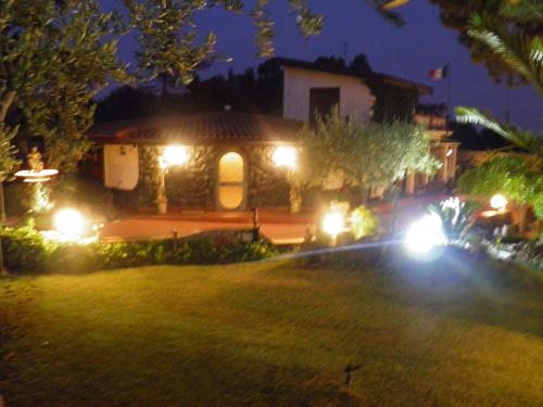 a house with lights in a yard at night at Parco Delle Tre Fontane in Nicolosi